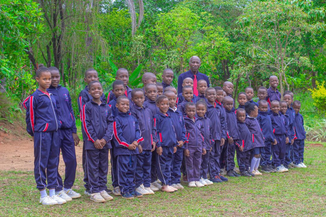 A group of Bethel College learners posing together outdoors