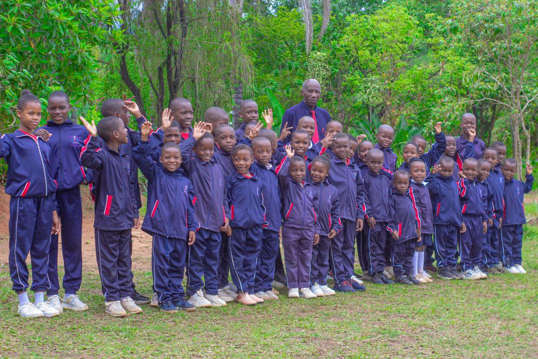 Bethel College learners standing together beside trees