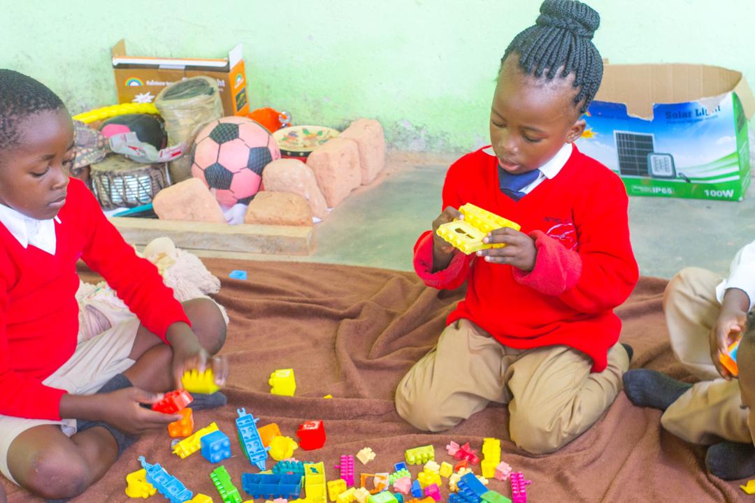 Young learners working with colourful building blocks