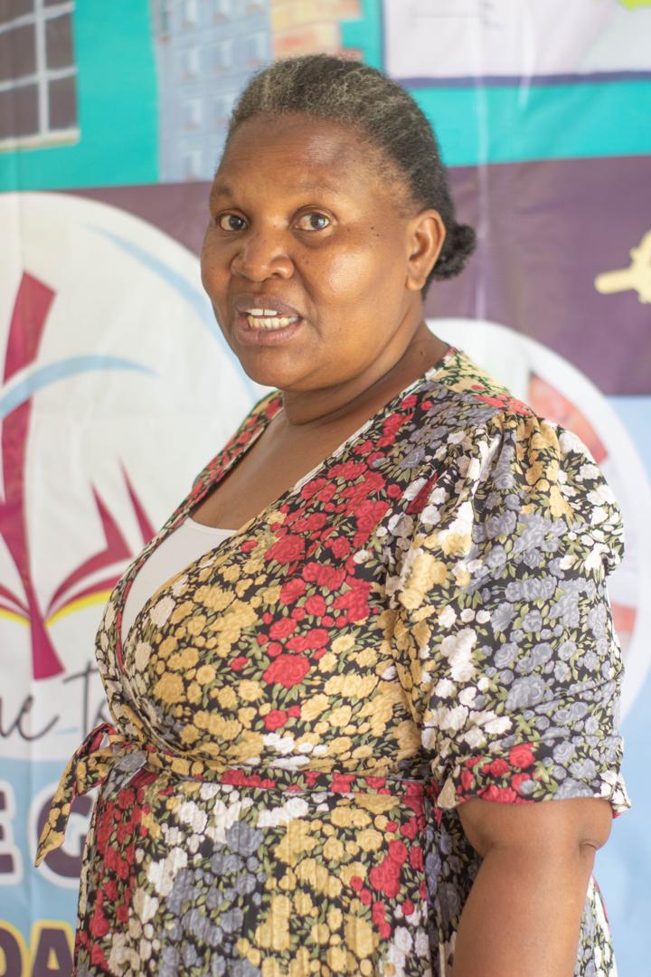 A member of the school community in front of a Bethel banner